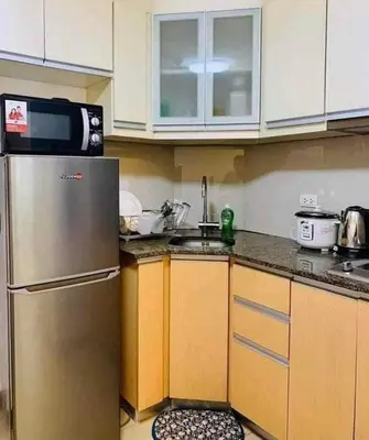 a kitchen with a stainless steel refrigerator and a sink at Staycation Unit at Two Palm Across Naia T3 with WIFI in Manila