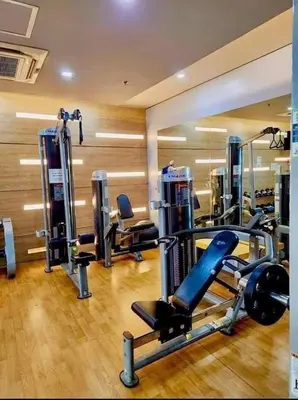 a gym with several tread machines in a room at Homey Studio at Two Palm Tree Across NAIA T3 Airport in Manila