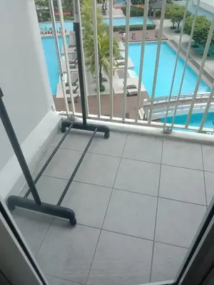 a balcony with a view of a swimming pool at Luxurious Condo in the Heart of Makati Philippines in Manila