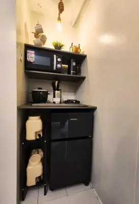 a small kitchen with a microwave and a stove at MetacasaStaycations-beside EK with Fireworks view in Santa Rosa