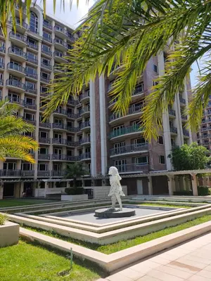 a statue in front of a large apartment building at Near Moa Facing pool view WP1603 Monarch Parksuites in Manila