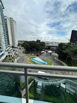 a view of a pool from a balcony in a city at Azure Staycations by MM 1 in Manila