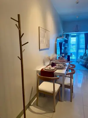 a dining room with a table and some chairs at Cozy & Stylist Unit in BGC in Manila