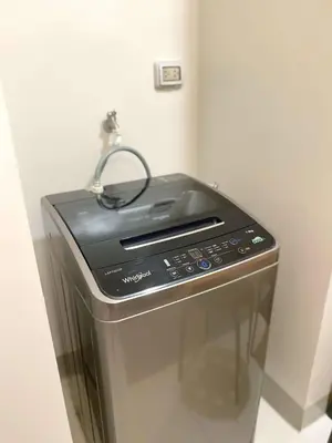 a toaster oven sitting in a corner of a room at Cozy & Stylist Unit in BGC in Manila