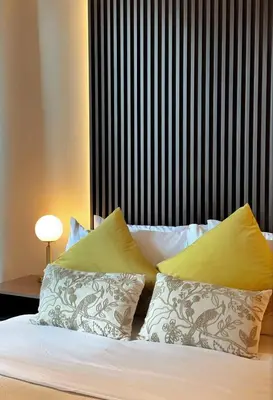 a bedroom with a bed with pillows and a lamp at Netflix and Chill Cozy Unit BGC in Manila