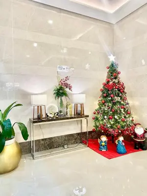 a christmas tree in the corner of a room at Chill Luxe Vista in Manila