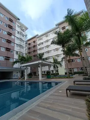 a swimming pool in front of a building at Regalia's Pod in Trece Martires