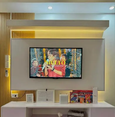 a flat screen tv hanging on a wall at Cozy Condo Staycation with Balcony near Mall of Asia in Manila