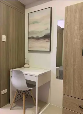 a white desk with a white chair in a room at Fame Residences One-Bedroom Condo Unit in Manila
