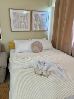 a bedroom with a bed with towels on it at Aurbana Staycation in Manila