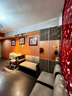 a living room with a couch and a table at Vintage Luxx-Solemare Parksuites Free Pool Access! in Manila
