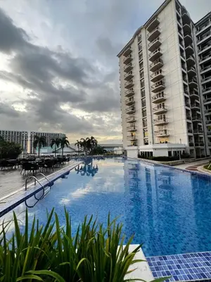 a large swimming pool next to two tall buildings at Vintage Luxx-Solemare Parksuites Free Pool Access! in Manila