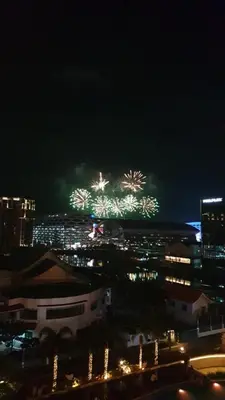 a city with fireworks in the sky at night at Vintage Luxx-Solemare Parksuites Free Pool Access! in Manila