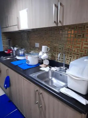 a kitchen with a sink and a counter top at Shore Residences Tower B near MOA and IKEA Pasay City in Manila