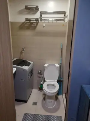 a small bathroom with a toilet and a sink at Shore Residences Tower B near MOA and IKEA Pasay City in Manila