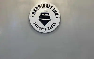 a sign on a wall that reads wakeville mine childrens hazard at OYO 1155 Carnivale Inn in Manila