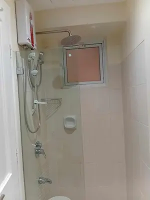 a bathroom with a shower and a toilet at Condo in Pasay 12th flr studio unit-near MOA, PICC in Manila