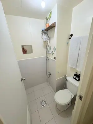 a white bathroom with a toilet and a sink at JJMC PLACE 28 With Netflix and Unli Wifi in Manila
