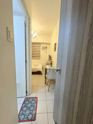 an open door to a room with a bedroom at JJMC HOMESTAY 29 with Netflix and Wifi in Manila