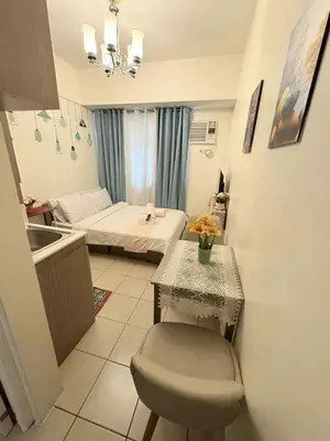 a bedroom with a bed and a table and a sink at JJMC PLACE 29 With Netflix and Unli Wifi in Manila
