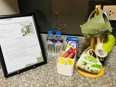 a picture of a table with a tablet and a bag at Astra Heights Staycation in Manila
