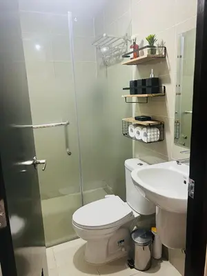 a bathroom with a toilet and a sink at Astra Heights Staycation in Manila