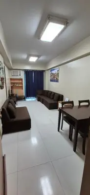 a living room with a couch and a table at Rqui Condotel Pasay City Manila in Manila