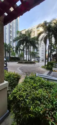 a view of a street with palm trees and buildings at Rooms in Pasay Manila Nearest To Airport Terminal 3 in Manila
