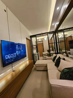 a living room with couches and a flat screen tv at Luxury apartment at Bloom Residences in Manila