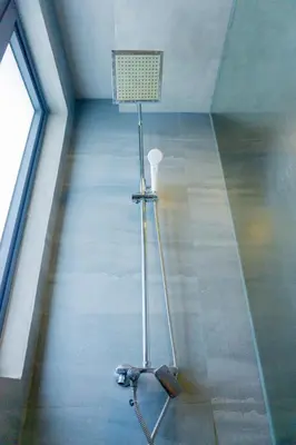a room with a lamp in the middle of a ceiling at Spacious Condo with 50in TV & Netflix, Near Malls in Manila