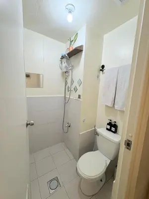 a bathroom with a toilet and a shower at JJMC HOMESTAY 28 With Netflix and Unli Wifi in Manila