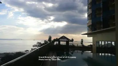 a view of the water from a balcony of a building at Grand Riviera Condotel Near St lukes Medical Center in Manila