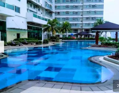a large swimming pool in front of a building at Zeke Suite At Beacon Tower Amorsolo unit 2330 in Manila