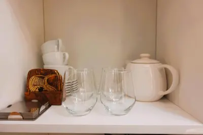 three empty wine glasses sitting on a shelf at F&M Deluxe Holiday Suite MOA SHORE 3 Residences