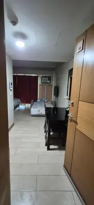 a hallway with a room with a desk and a bedroom at Condotel in Pasay City Manila in Manila