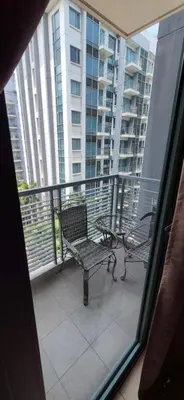 a balcony with two benches and a view of a building at Condotel in Pasay City Manila in Manila