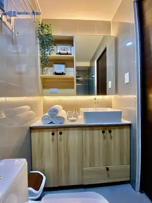 a bathroom with a sink and a mirror at Edin's Home in Manila