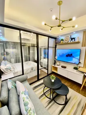 a living room with a couch and a tv and a bed at Edin's Home in Manila