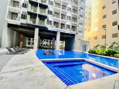 a swimming pool in the middle of a building at Calix Suite in Manila