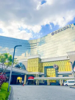 a building with a sign on the side of it at Luxury and Modern 1 Bedroom near Solaire, Okada in Manila