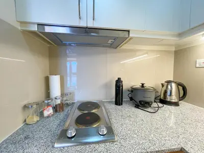 a kitchen counter with a stove top in a kitchen at Luxury and Modern 1 Bedroom near Solaire, Okada in Manila