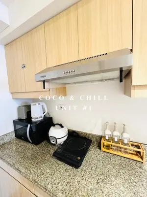 a kitchen with a counter top with a toaster and a stove at Condotels near NAIA in Manila