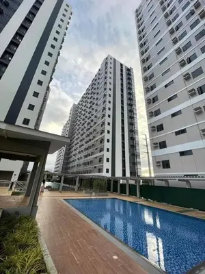 two tall buildings with a swimming pool in front of them at Furnished Condo Unit-Green2 PoolWifiNetflix in Dasmariñas
