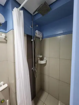 a bathroom with a shower with a blue ceiling at Condo Near World Trade, Star City and PICC - Amazing Breeze in Manila