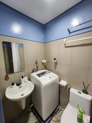 a small bathroom with a toilet and a sink at Condo Near World Trade, Star City and PICC - Amazing Breeze in Manila