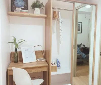 a room with a desk with a chair and a mirror at FLAT ESHRA - Cozy Bright 1-BR in Manila