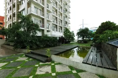 a building with a pond in front of a building at FLAT ESHRA - Cozy Bright 1-BR in Manila