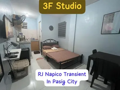 a small bedroom with a bed and a piano at RJ Wallfan Studio Transient in Napico, Lifehomes Pasig City in Manila