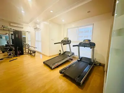a gym with two tread machines in a room at Unwind Oasis Two Bedroom Free Pool Access in Manila