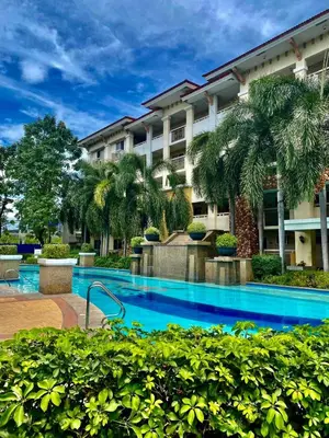 a swimming pool in front of a building at Unwind Oasis Two Bedroom Free Pool Access in Manila